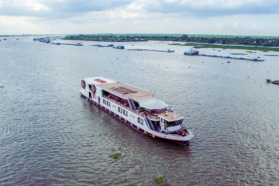 Mekong Delta overnight cruise boat sailing through peaceful riverside villages